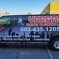 A varga carpet cleaning van is parked in a parking lot.