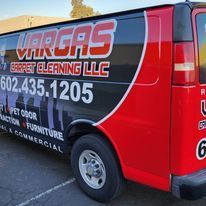 A red van is parked in a parking lot.