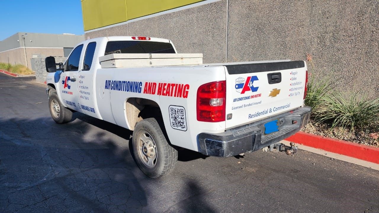 A white truck is parked on the side of the road.