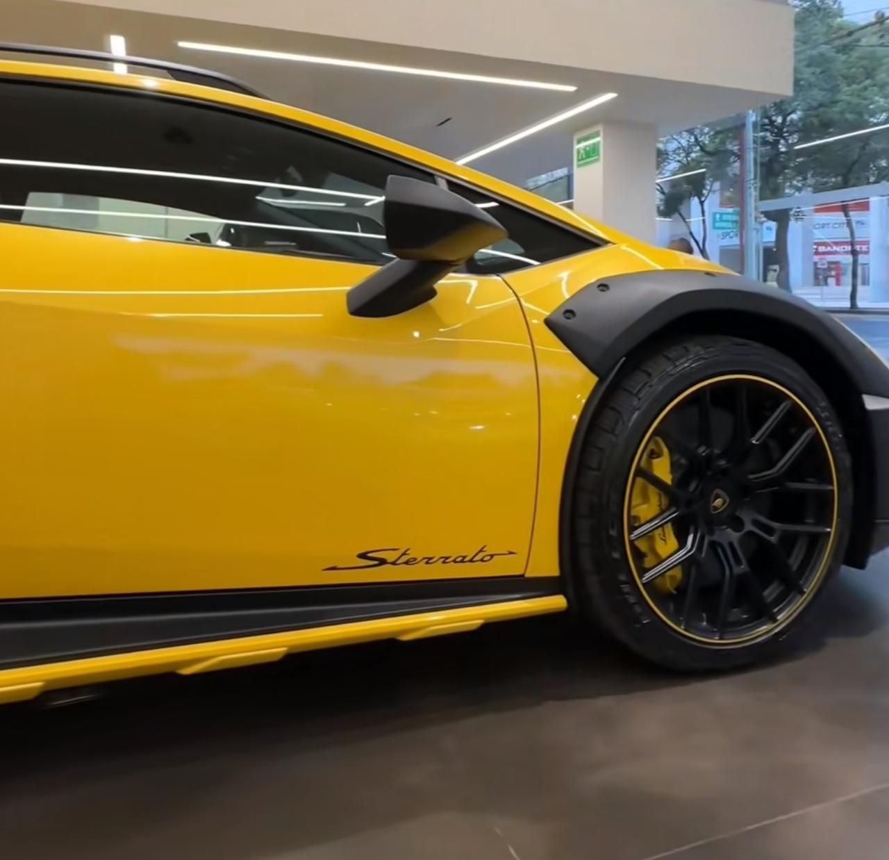 A yellow lamborghini is parked in a showroom