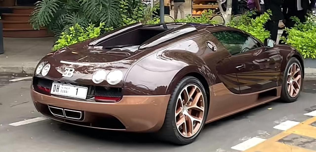A brown sports car is parked on the side of the road.