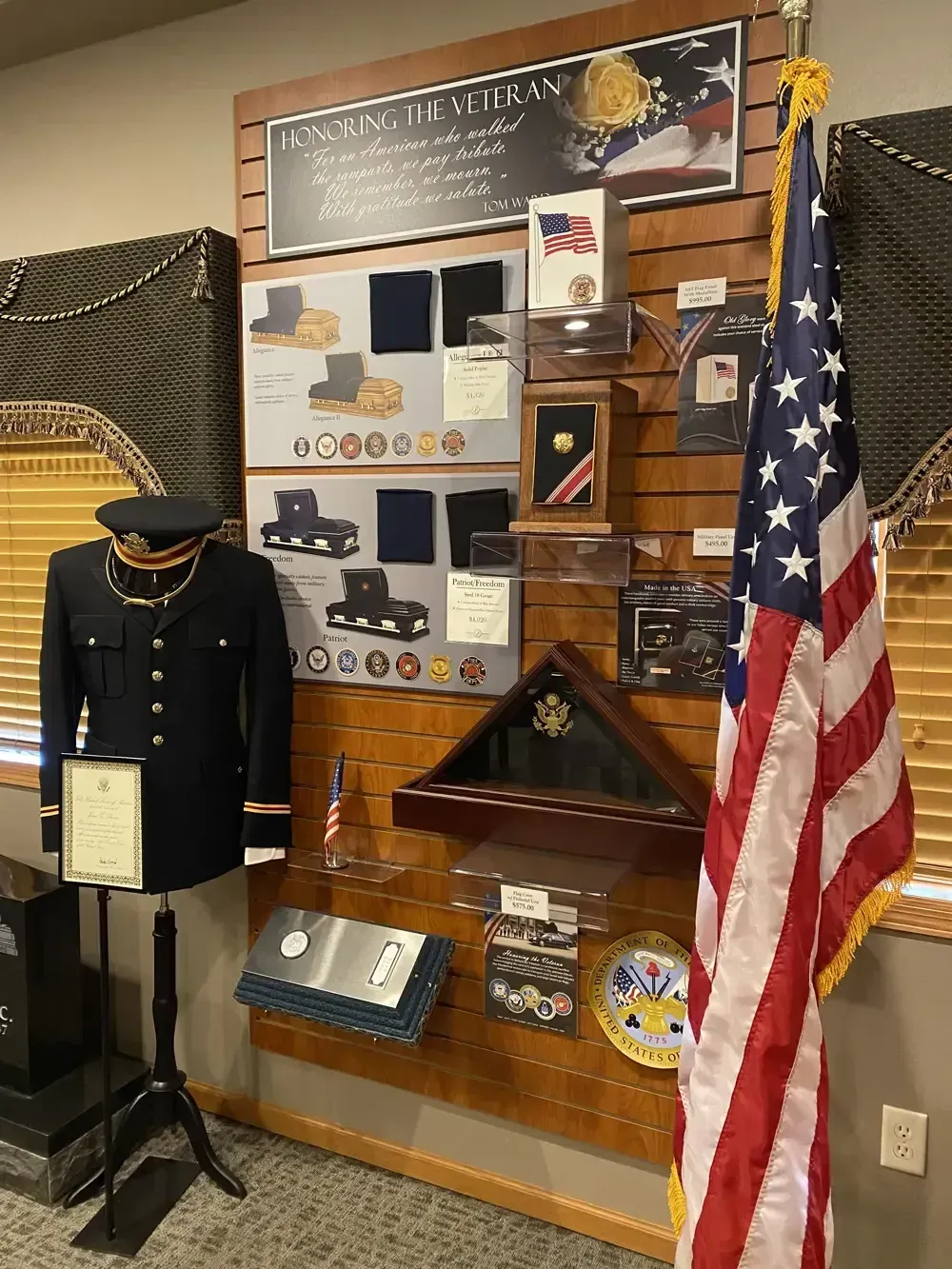 Museum display of military memorabilia, including a Navy uniform, American flag, and historical artifacts.