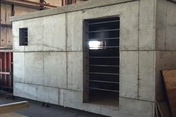 Indoor view of a precast concrete block wall panel with window openings during construction for a concrete block retaining wall service in Heber City, UT