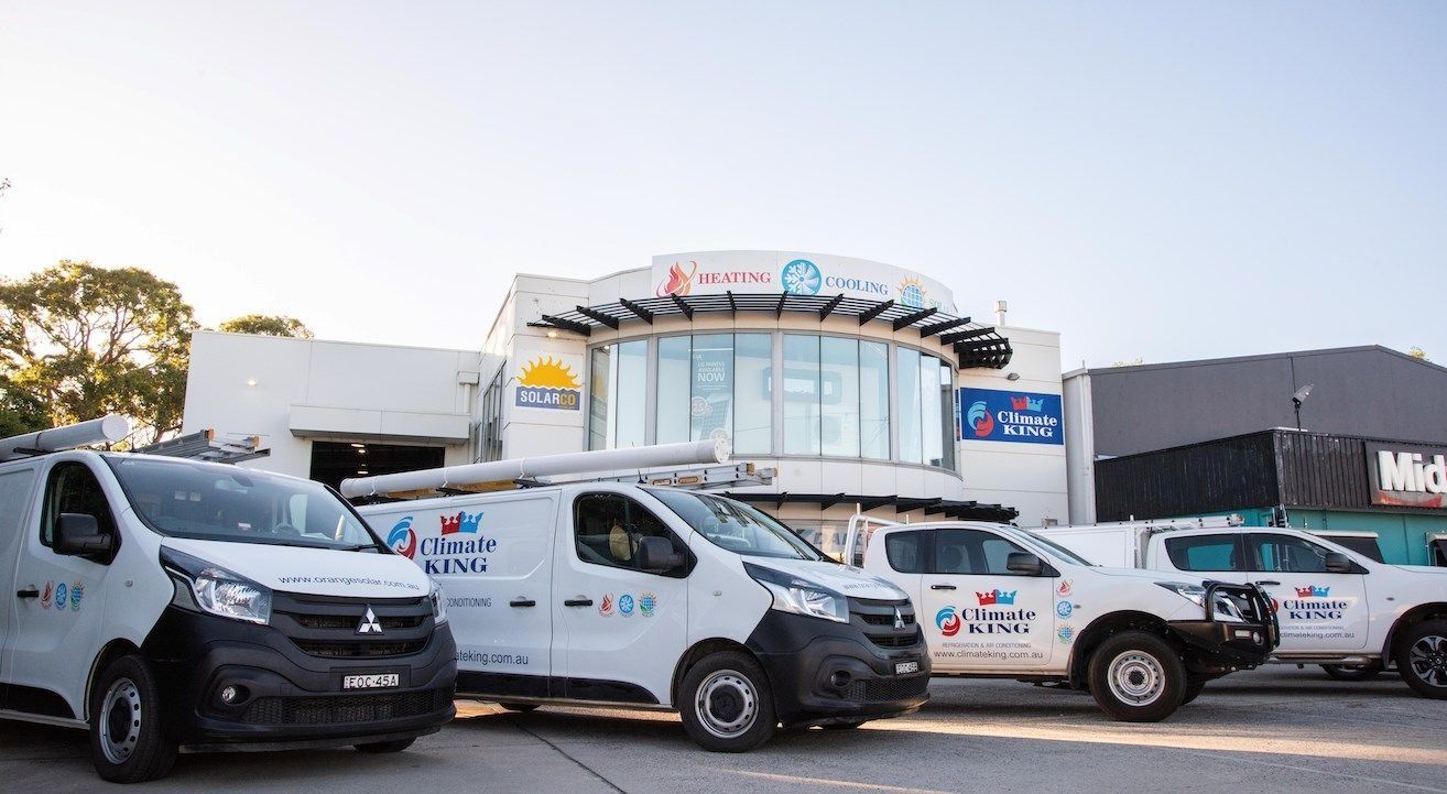Climate King Service Vans Parked Outside a Commercial Building — Climate King In Orange, NSW