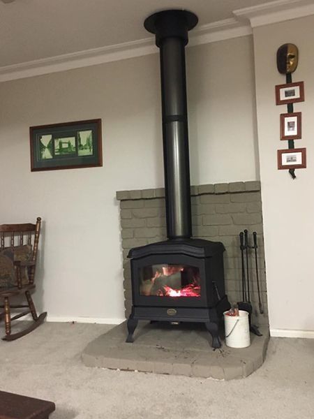 a Lit Black Wood-burning Stove With a Chimney — Climate King In Parkes, NSW