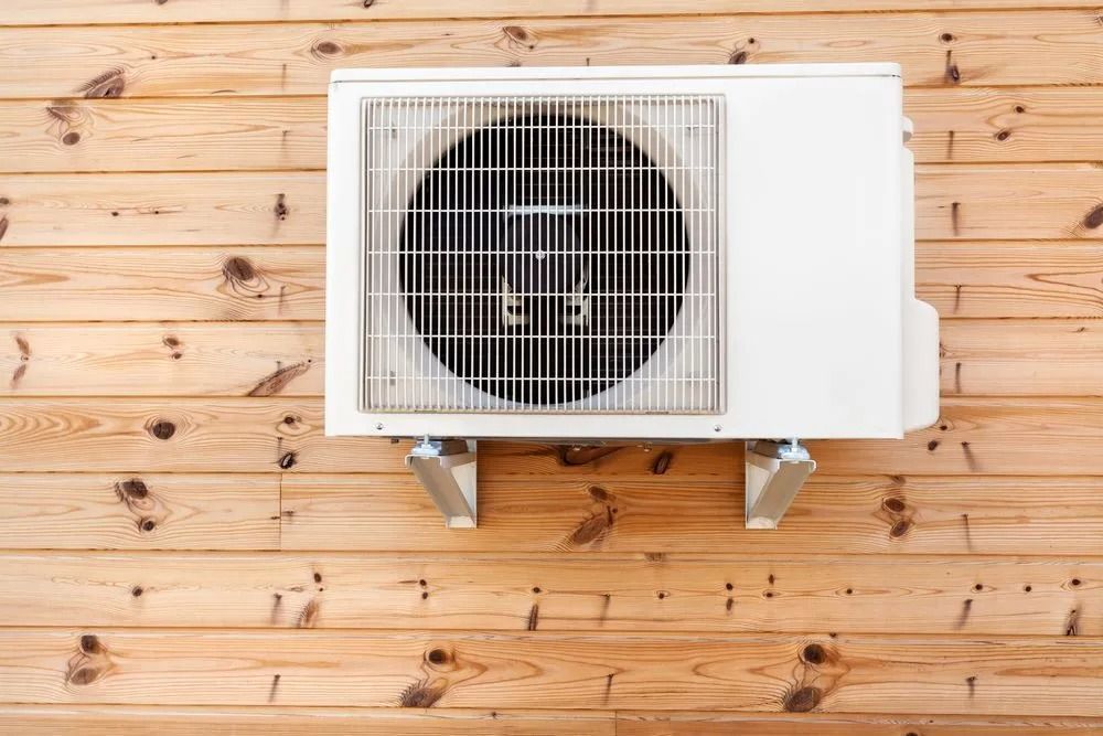 White Air Conditioning Unit Mounted on a Wooden Wall — Climate King In Orange, NSW