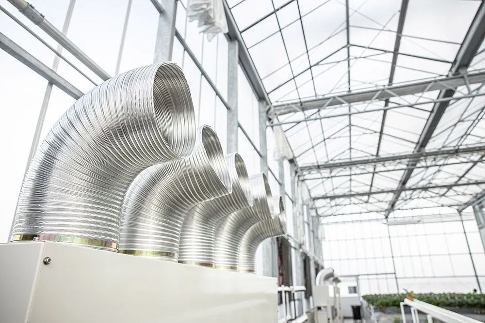 Flexible Silver Ventilation Ducts in a White Industrial Building — Climate King In Orange, NSW