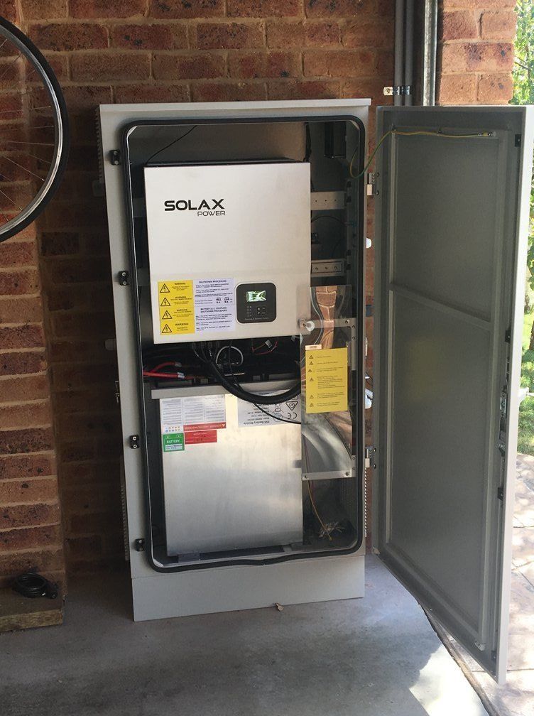 Open Grey Metal Cabinet on Brick Wall — Climate King In Parkes, NSW