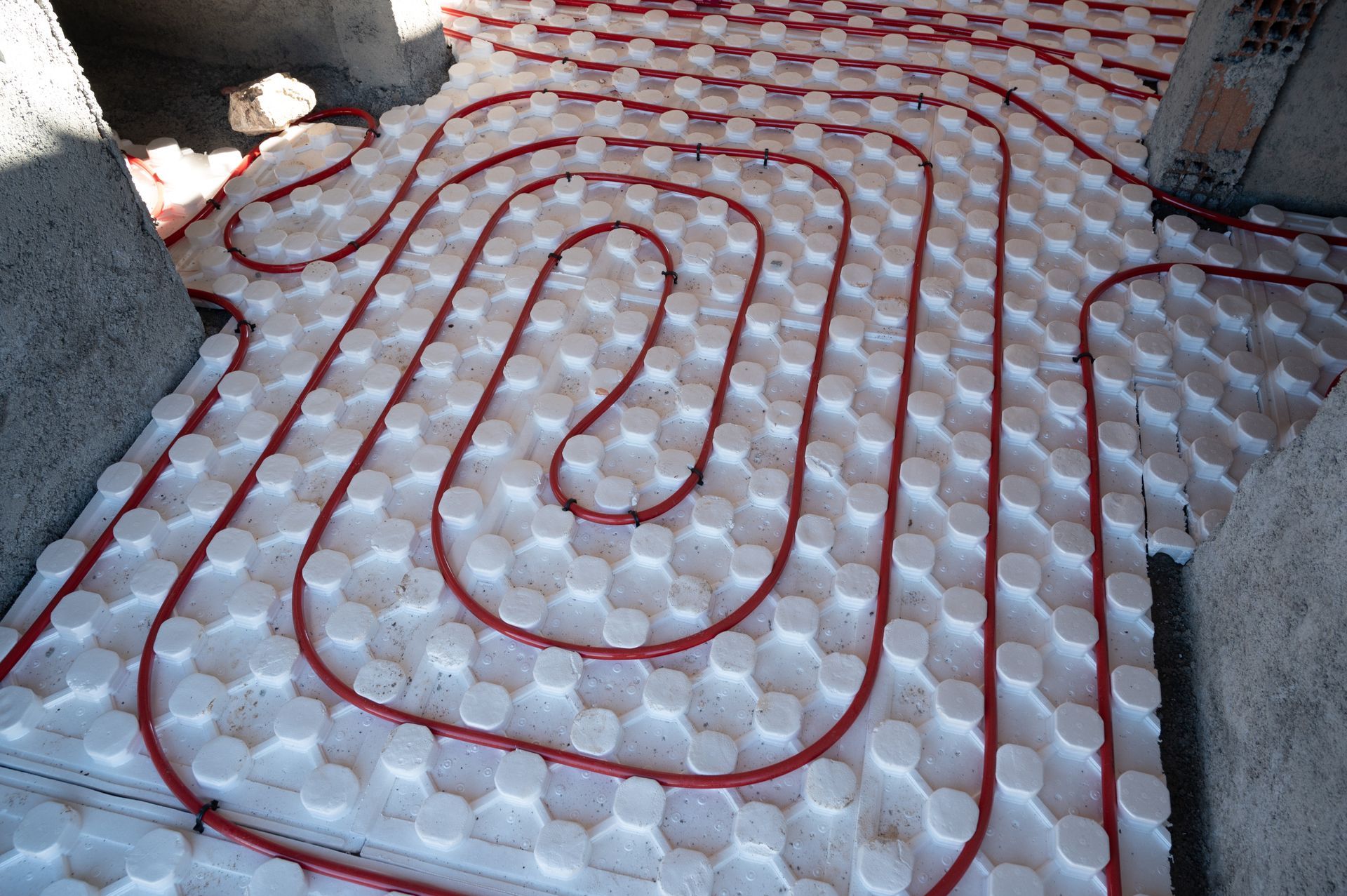 Red Pipes Laid in a Spiral Pattern Across White — Climate King In Orange, NSW
