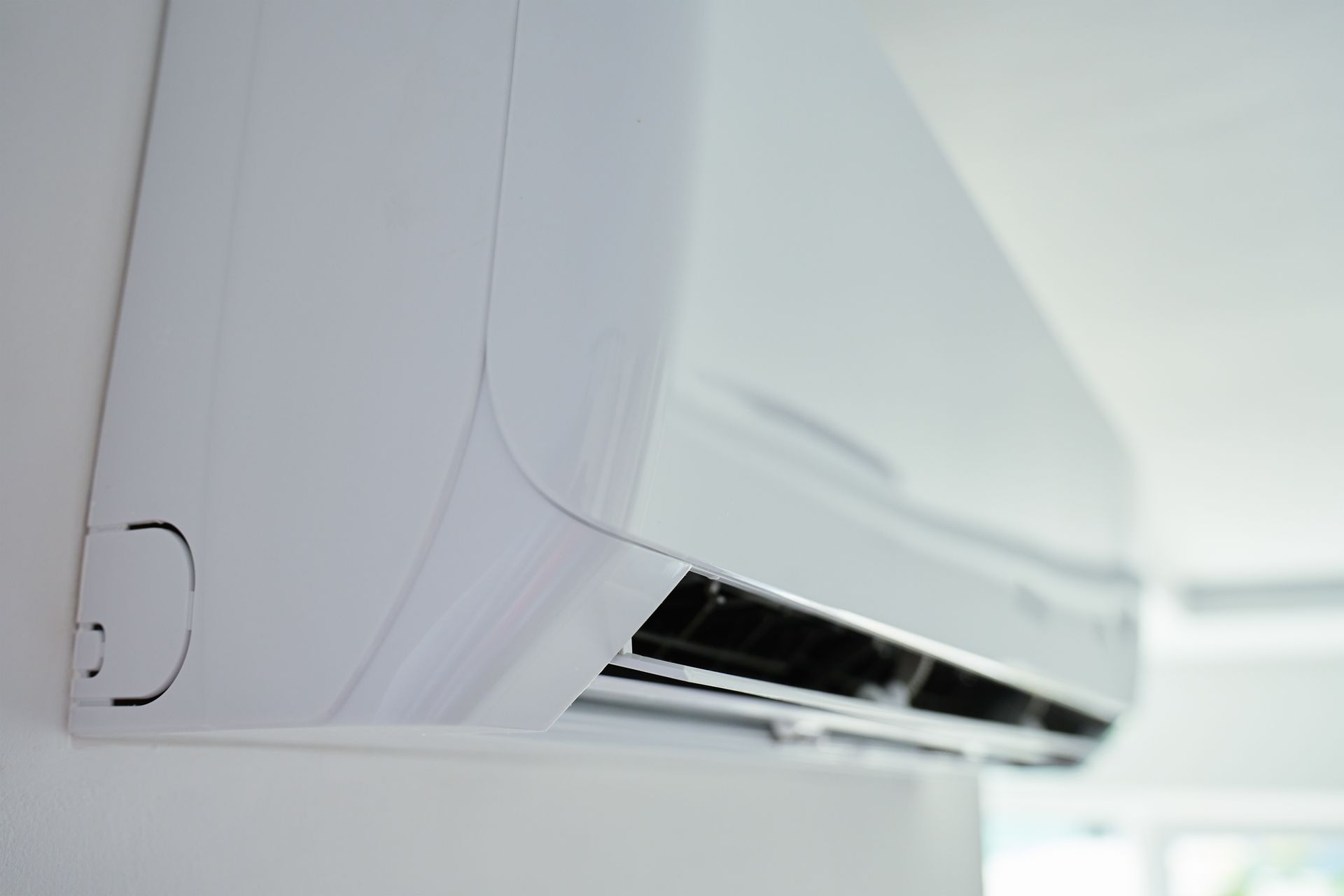 White Air Conditioner Mounted on a White Wall, Indoors — Climate King In Orange, NSW