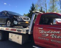 A car is being towed by a tow truck.