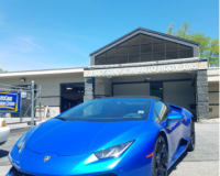 A blue lamborghini is parked in front of a building