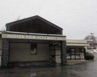 The front of a building with a sign that says hudson view auto body inc.