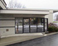 A large building with a lot of windows and a covered entrance.