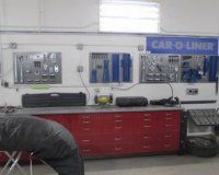 A man is working on a car in a garage.