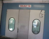 A paint booth with two doors and two windows.