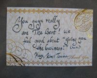 A business card with a handwritten message on it.