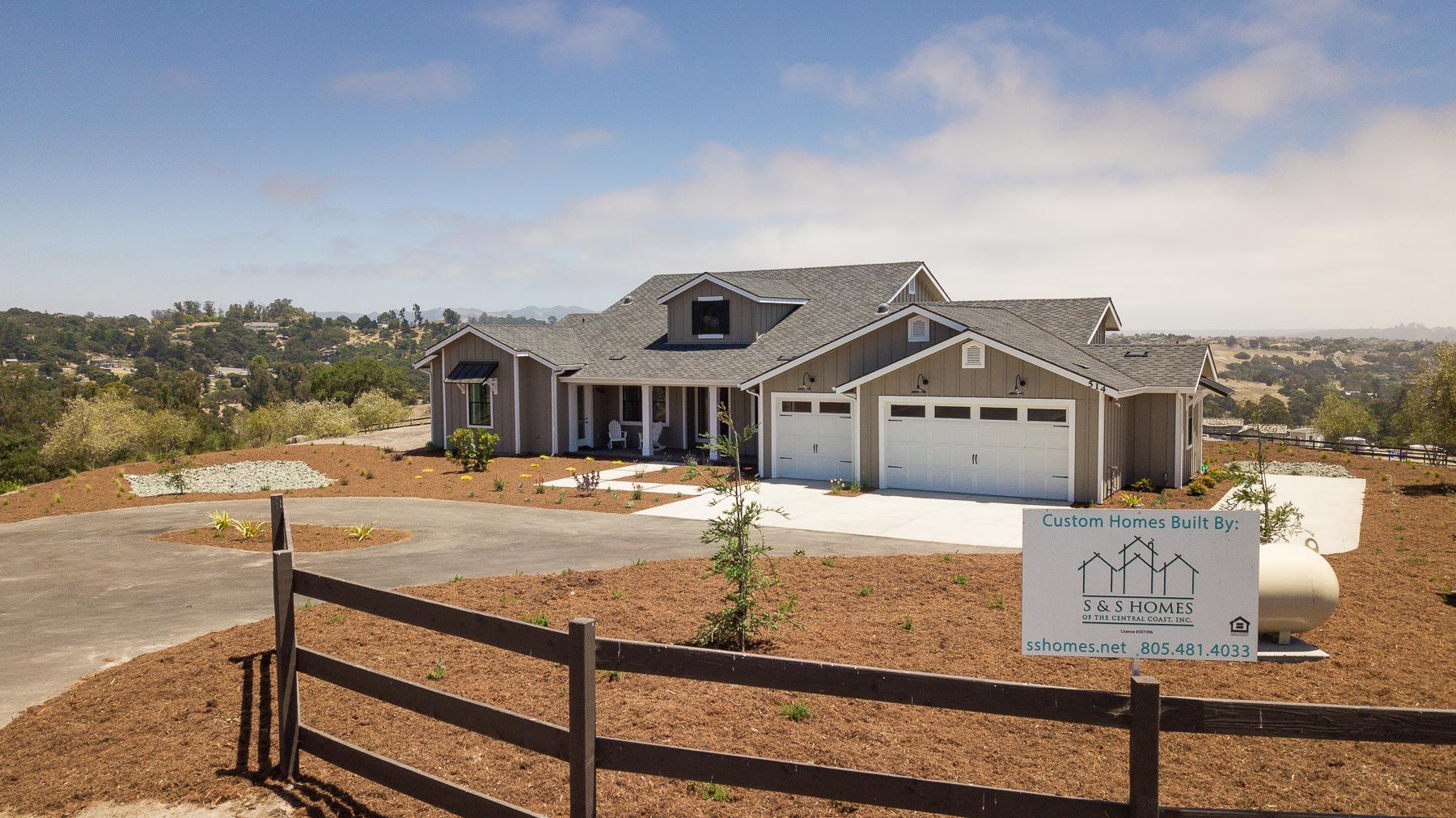 A house with a fence and a sign in front of it