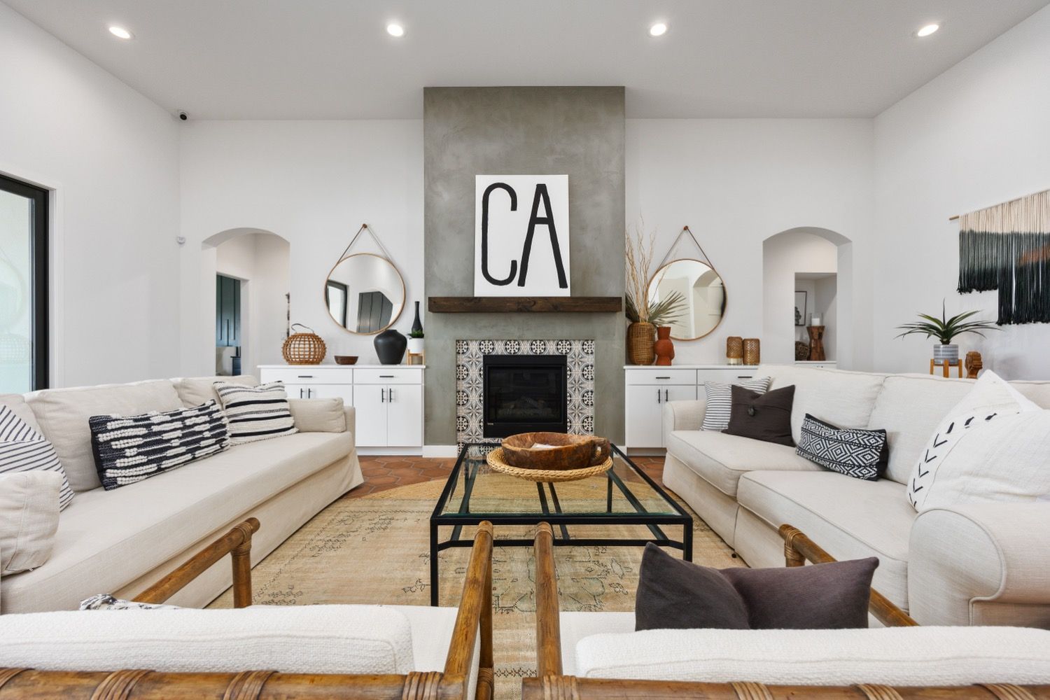 Living room with two white couches, fireplace, and