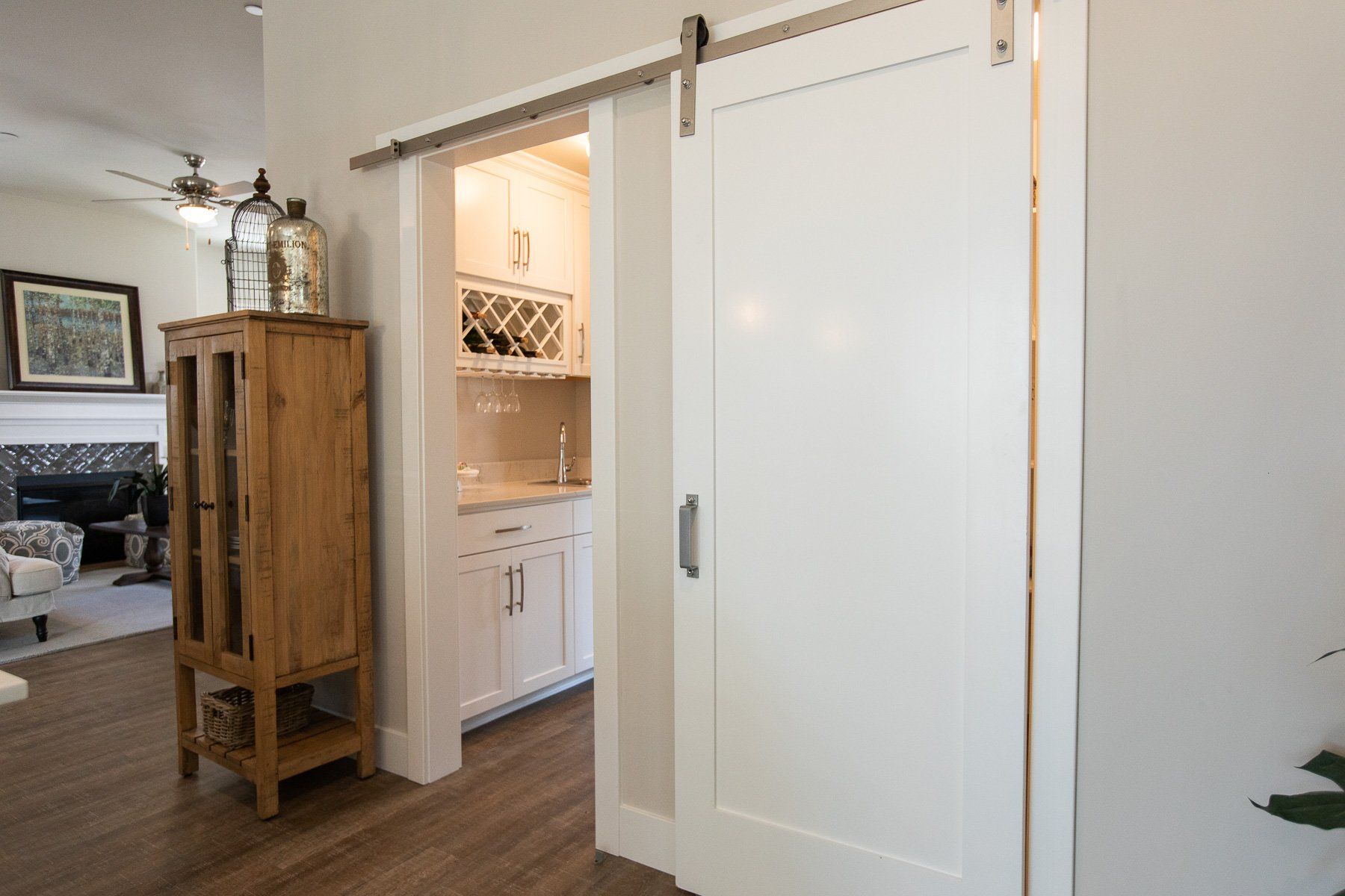 There is a sliding barn door between the living room and the kitchen.