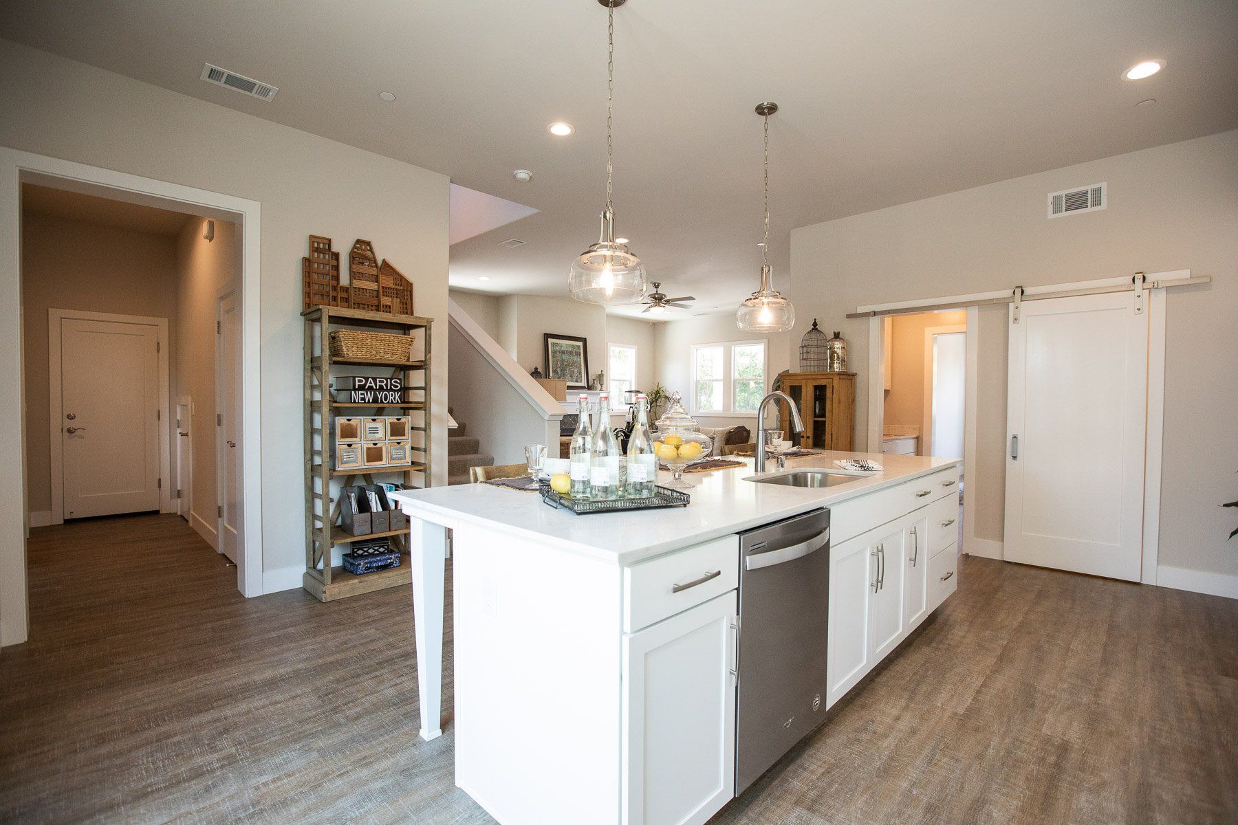 A kitchen with a large island and stainless steel appliances.
