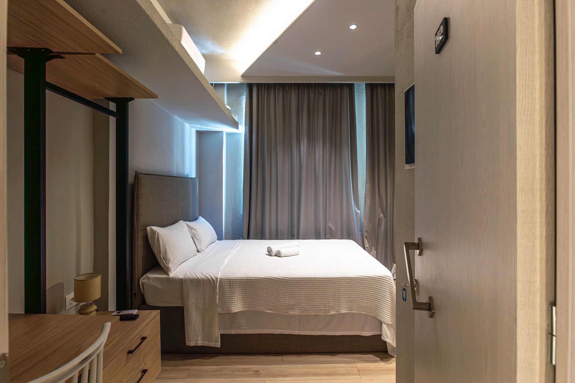 Bedroom interior with a bed, dresser, and partial view of a closet.