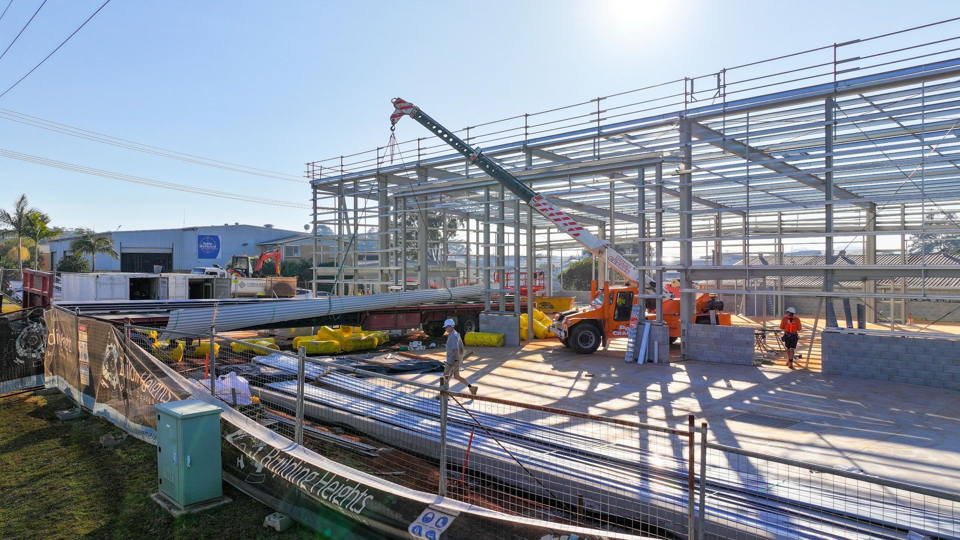 A Large Building is Being Built on a Sunny Day — Roofing Contractor in Taree, NSW