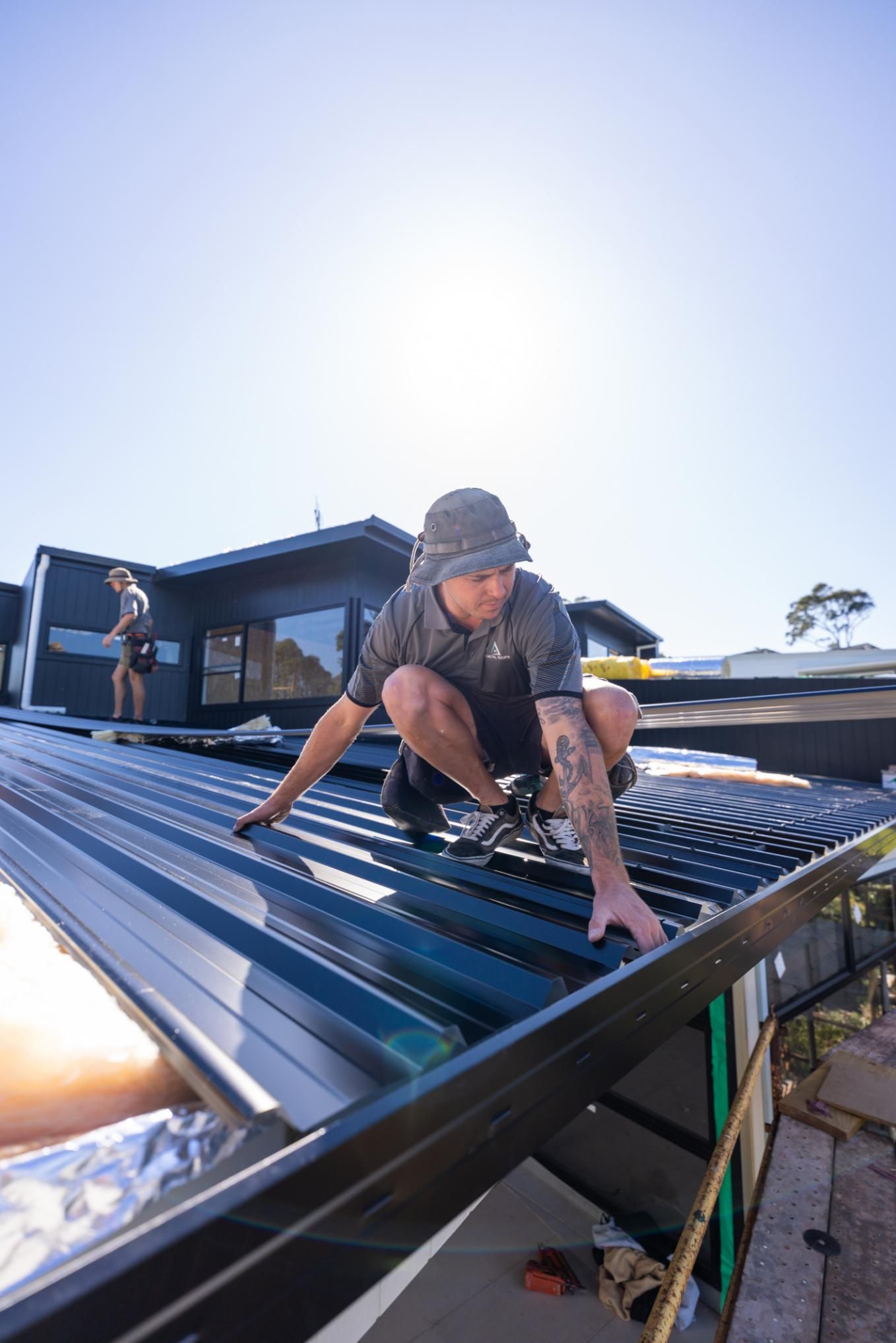 Man Is Installing Aluminum Roof — Roofing Contractor in Forster, NSW