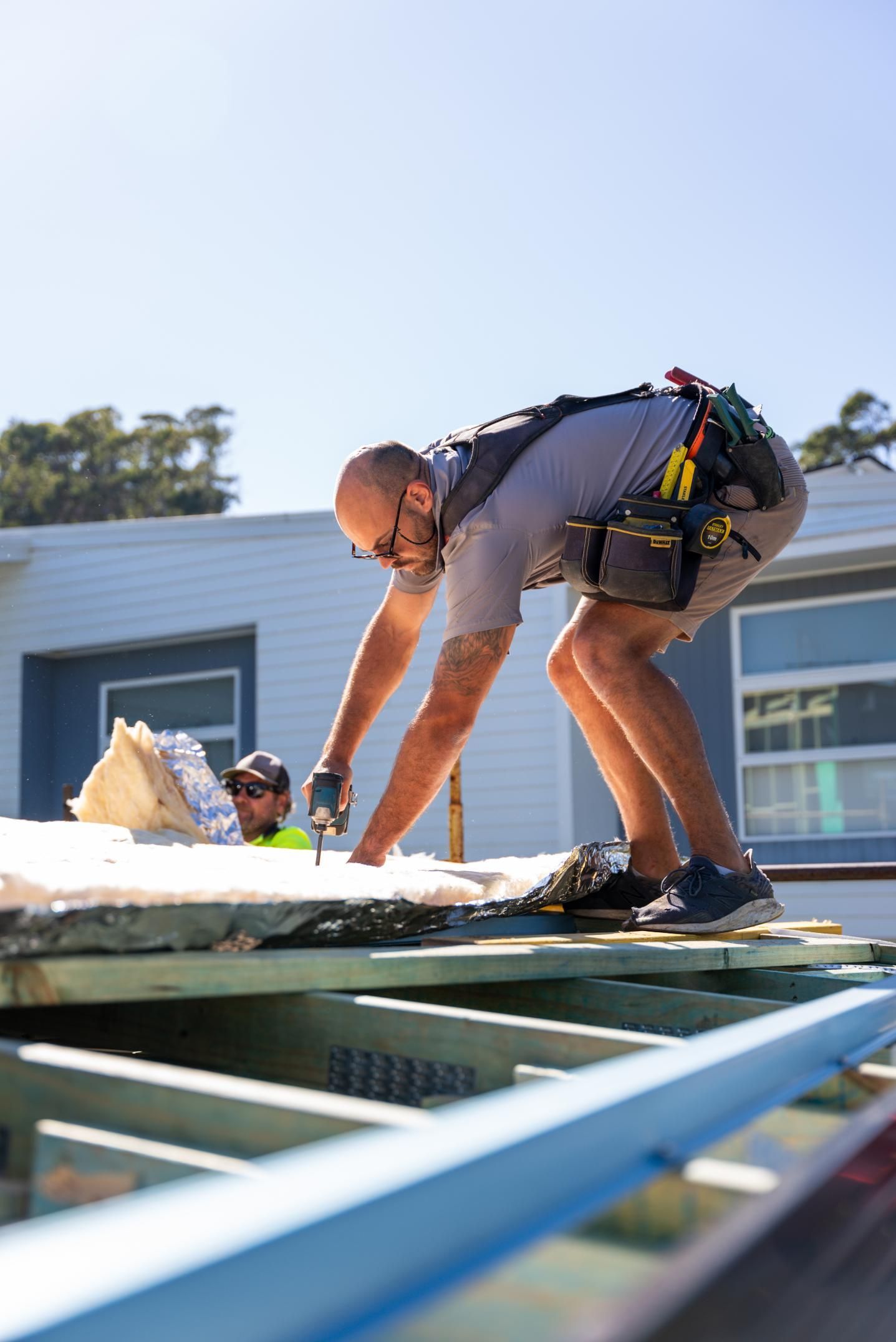 Construction Workers are Working On The House Roof — Roofing Contractor in Kempsey, NSW