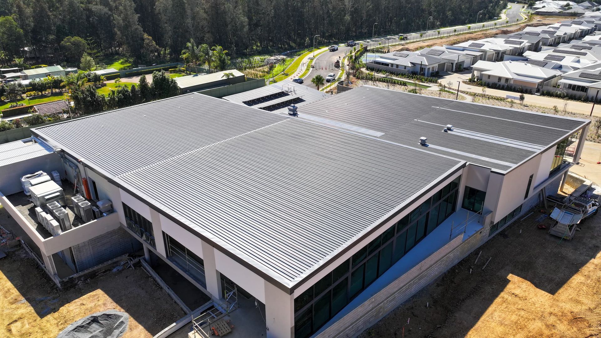 A Crane is Lifting a Metal Structure at a Construction Site — Roofing Contractor in Wauchope, NSW