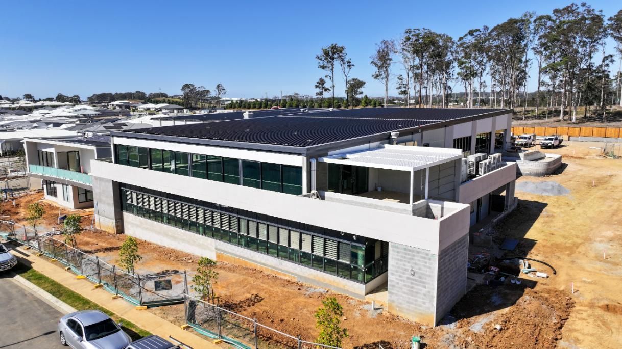 Under Construction Building With Solar Panels on the Roof — Roofing Contractor in Port Macquarie, NSW
