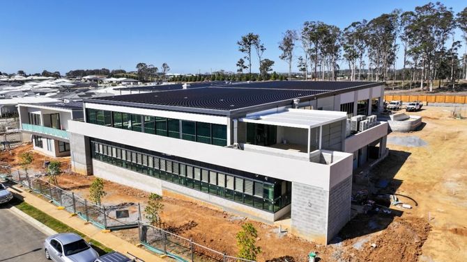 Modern Design of a Building With Solar Panel on the Roof — Roofing Contractor in Wauchope, NSW