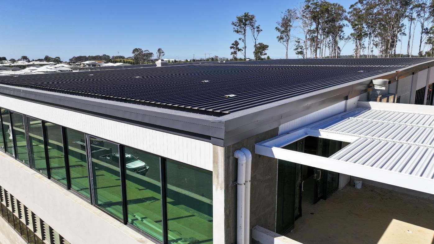 Modern Design of a Building With Solar Panel on the Roof — Roofing Contractor in Forster, NSW
