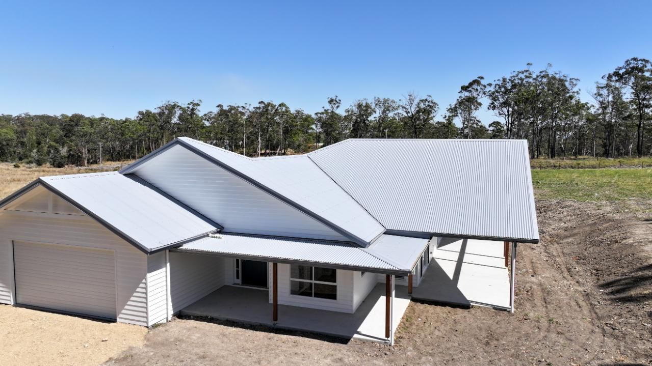 An Aerial View of a Building Under Construction With a Black Roof — Roofing Contractor in Wauchope, NSW
