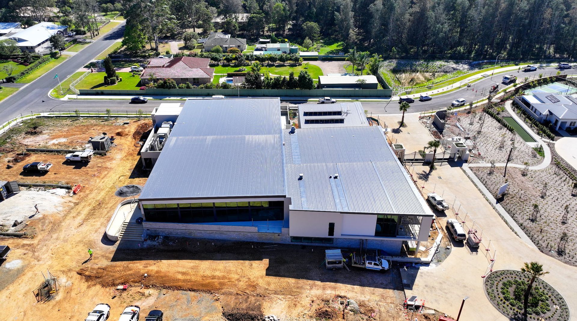 A Man is Sitting on Top of a Metal Structure at a Construction Site — Roofing Contractor in Wauchope, NSW