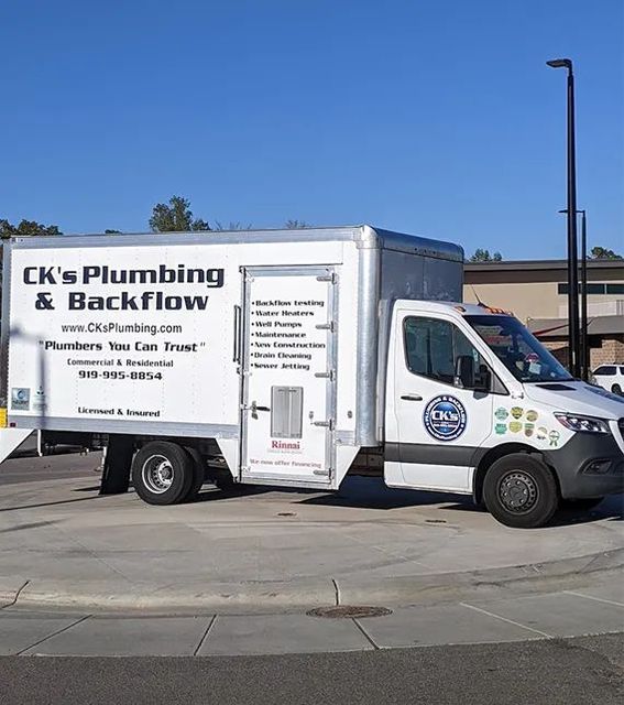 CK’s Plumbing & Backflow service truck parked on a street under a blue sky