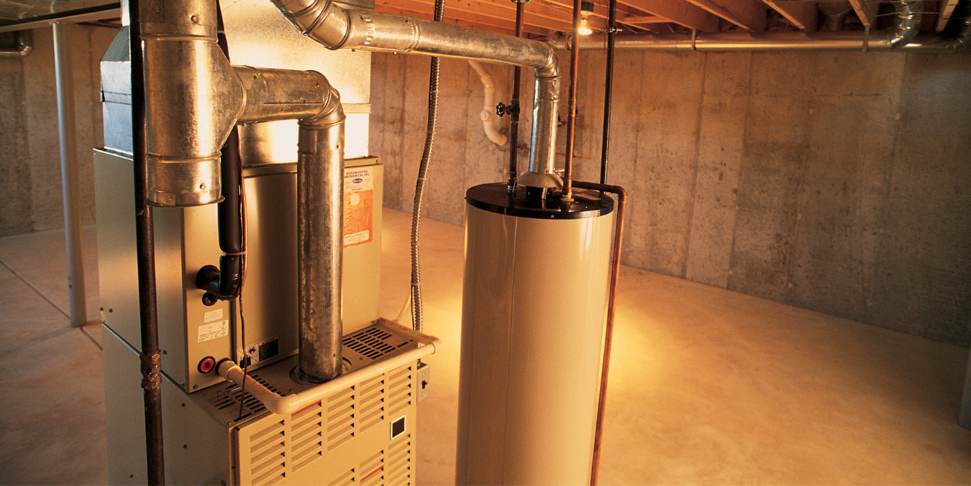 A basement with a heater and a water heater in it.
