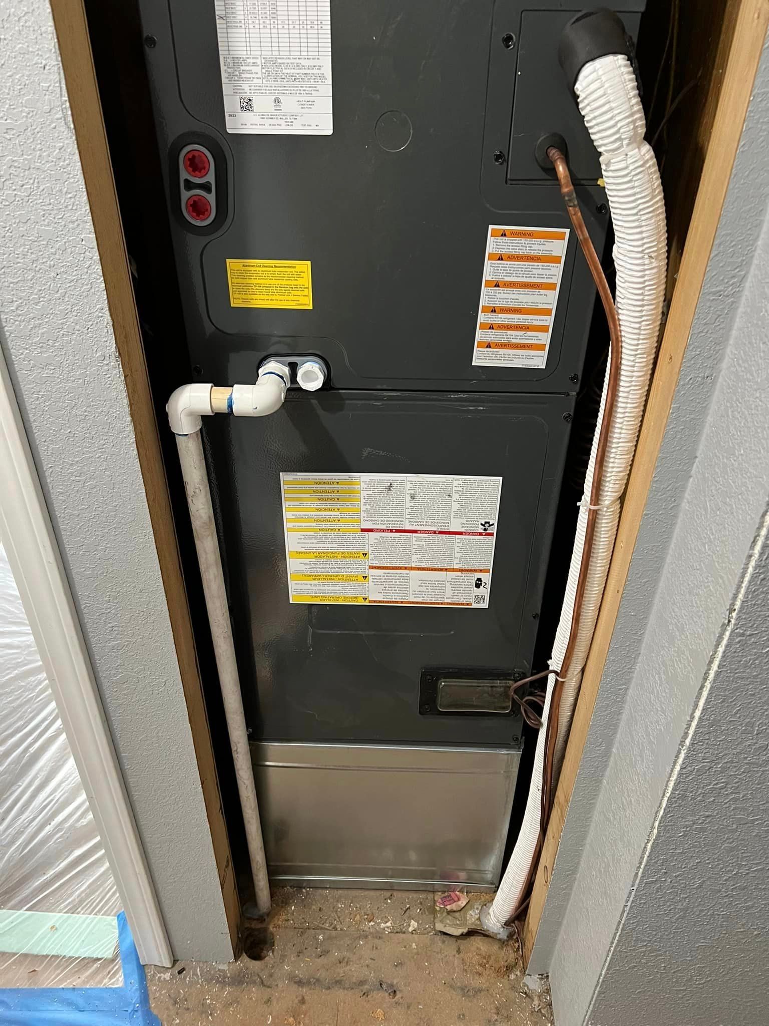 A picture of an air conditioner in a closet.