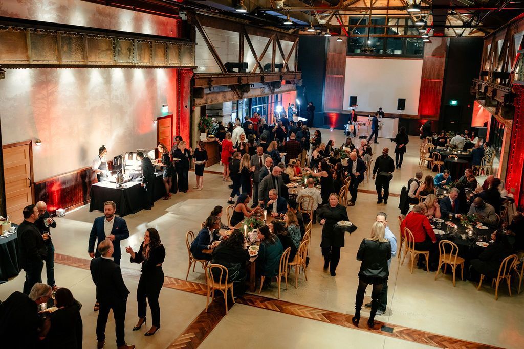 Corporate event in Philadelphia featuring professional DJ entertainment, ambient lighting, and guests networking in a sophisticated venue.