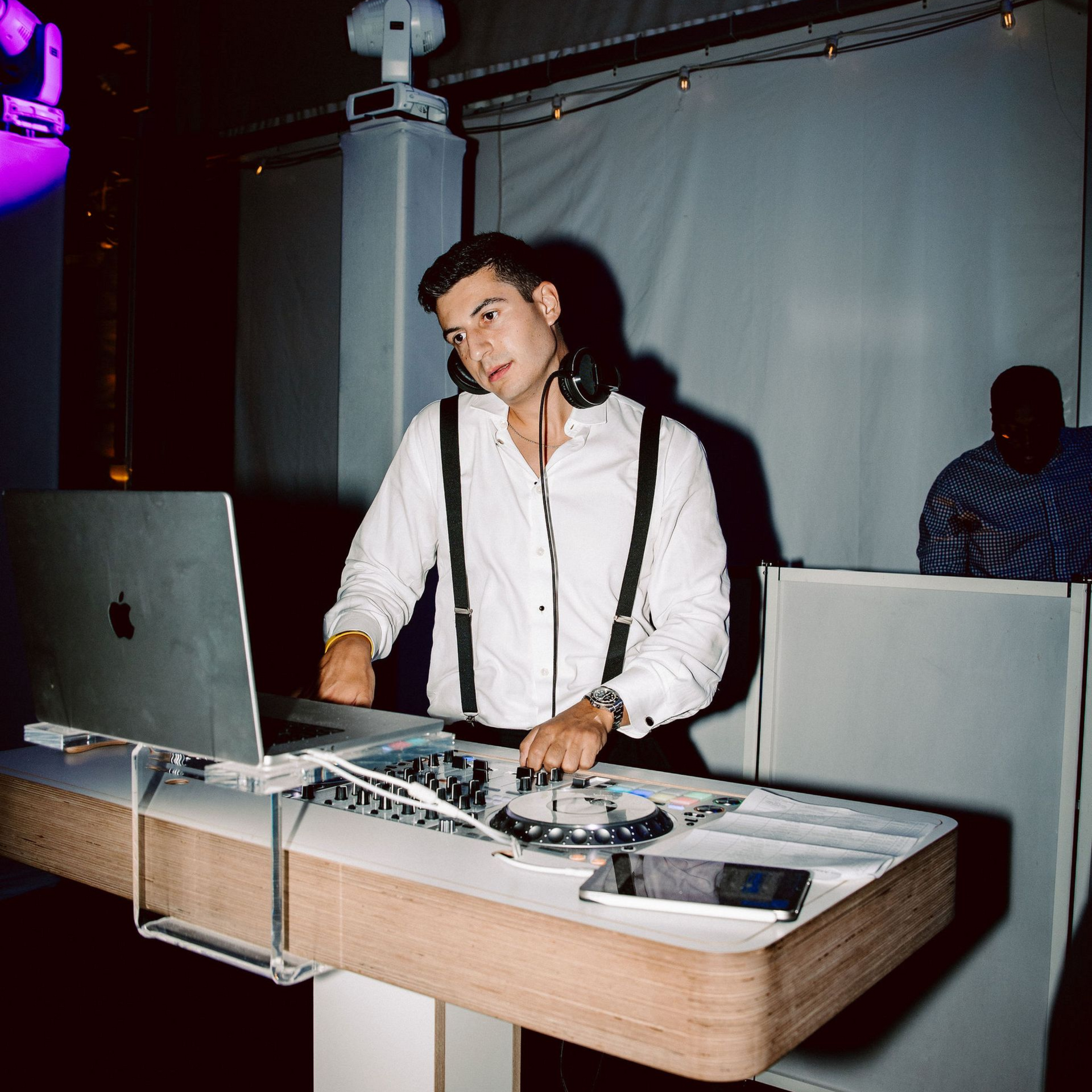 DJ mixing live at a wedding reception, keeping guests on the dance floor with high-energy music.