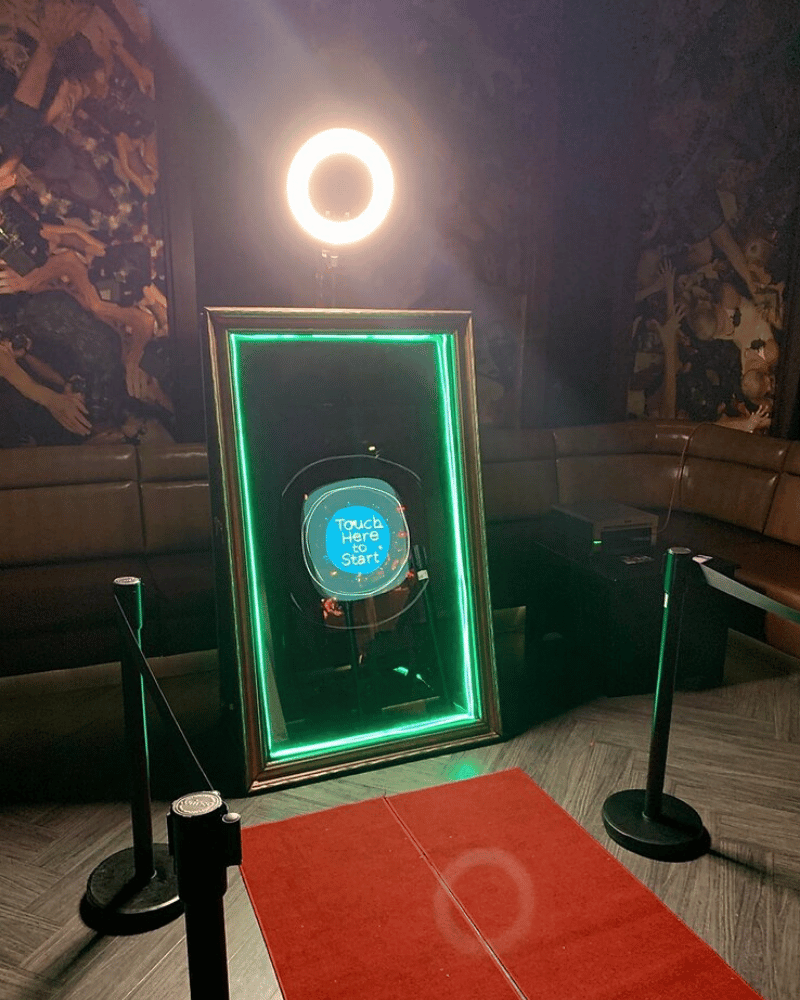 The Magic Mirror photo booth stands out with its interactive touch screen and elegant frame.