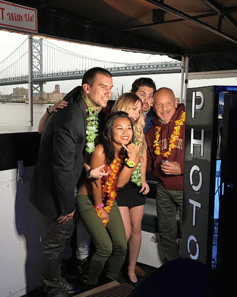 An open-air photo booth setup, featuring guests having fun against a scenic background.