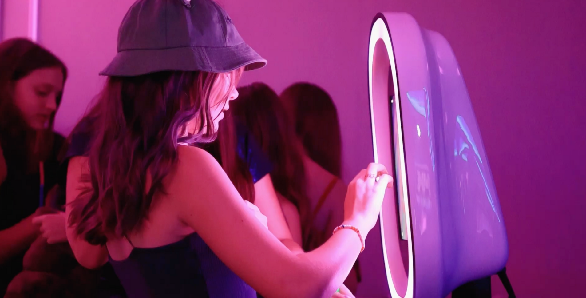 Interactive photo booth with LED lighting at a vibrant event, capturing attendees' memorable moments in style.