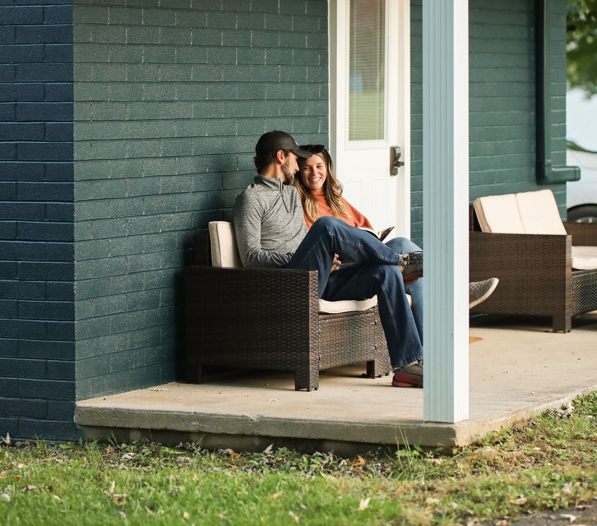 A man and a woman are sitting on a porch