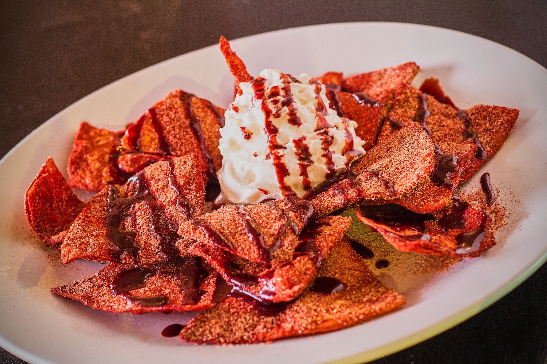 Cinnamon and sugar-coated chips with strawberry sauce and whipped cream.
