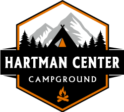 A logo for hartman center campground with a tent and mountains in the background.