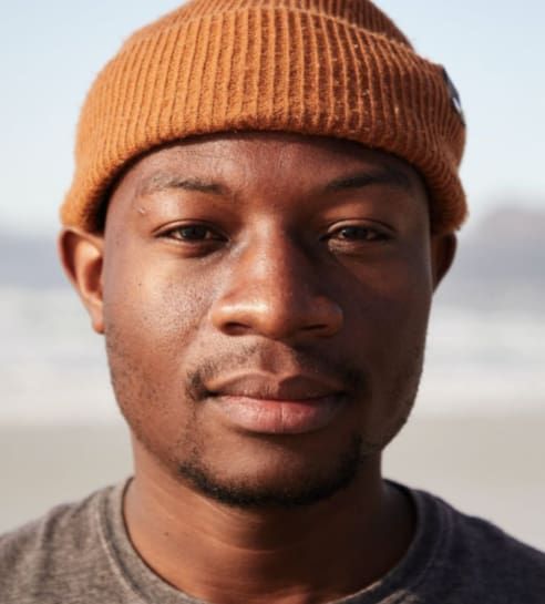 Man with brown beanie, neutral expression