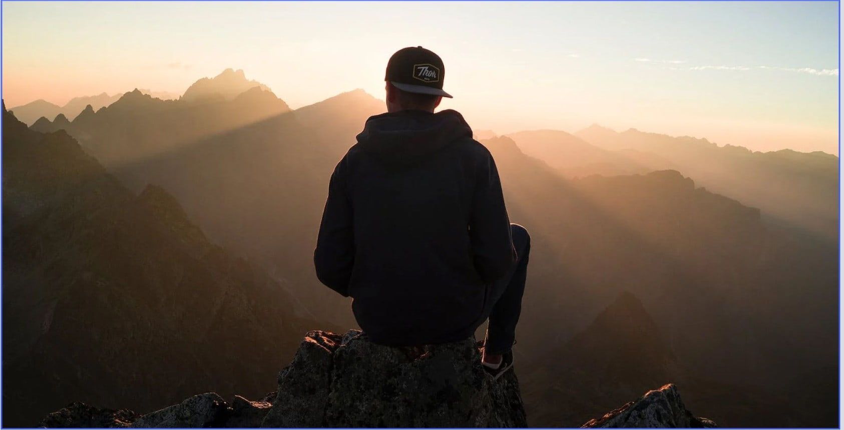 Eroded red sandstone canyon walls, sunlight filtering through narrow opening.