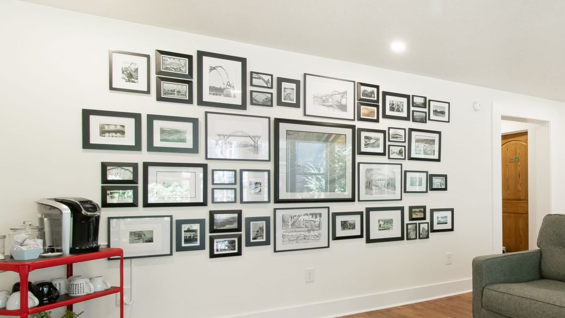 A living room with a lot of pictures on the wall.