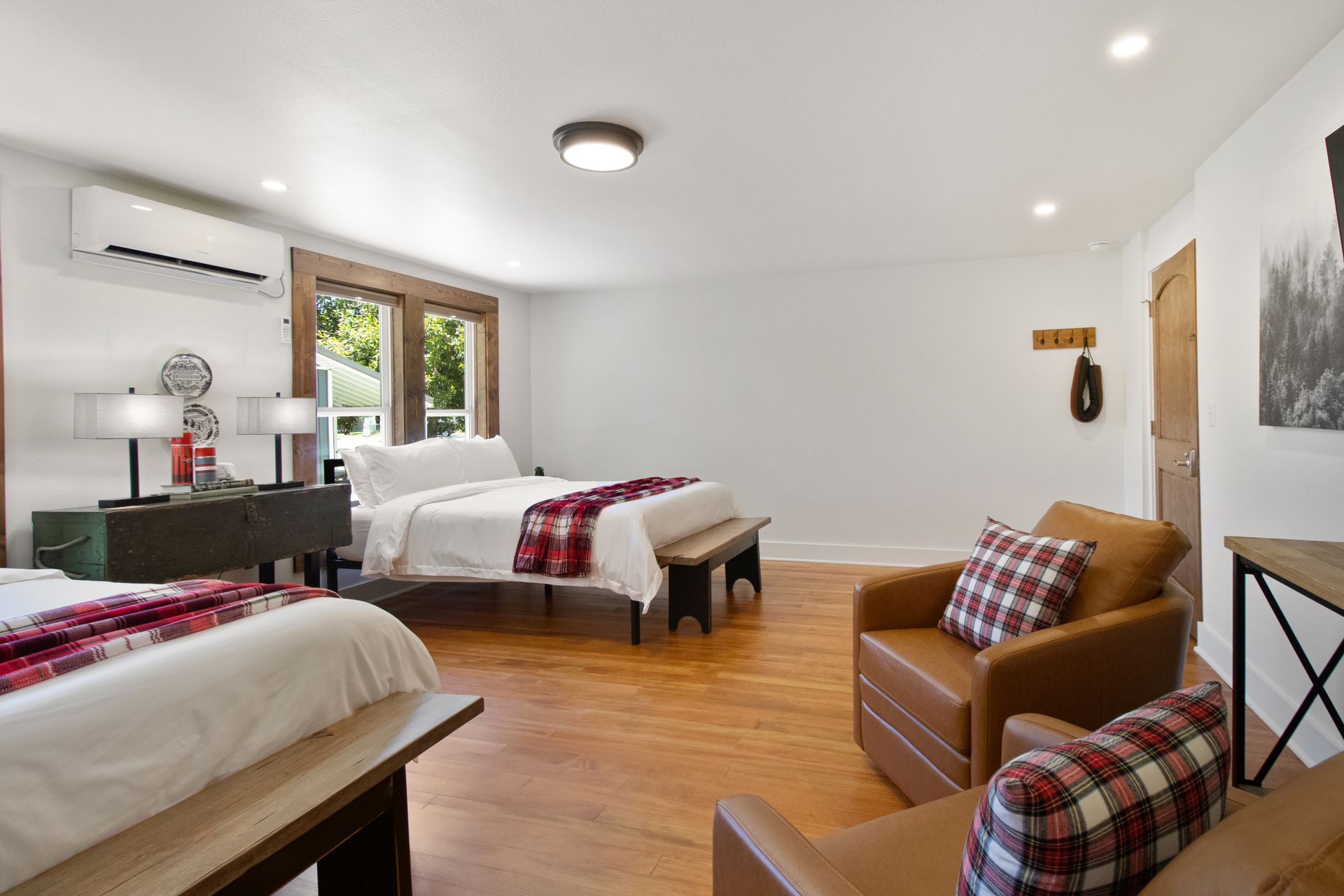There are two beds and a chair in the room.